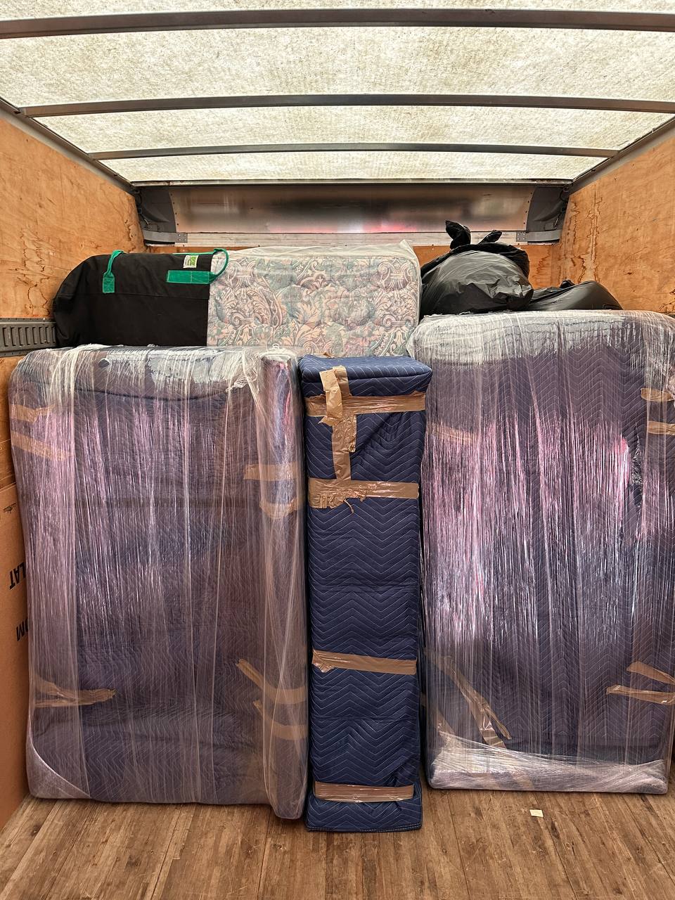 Organized moving truck with wrapped furniture
