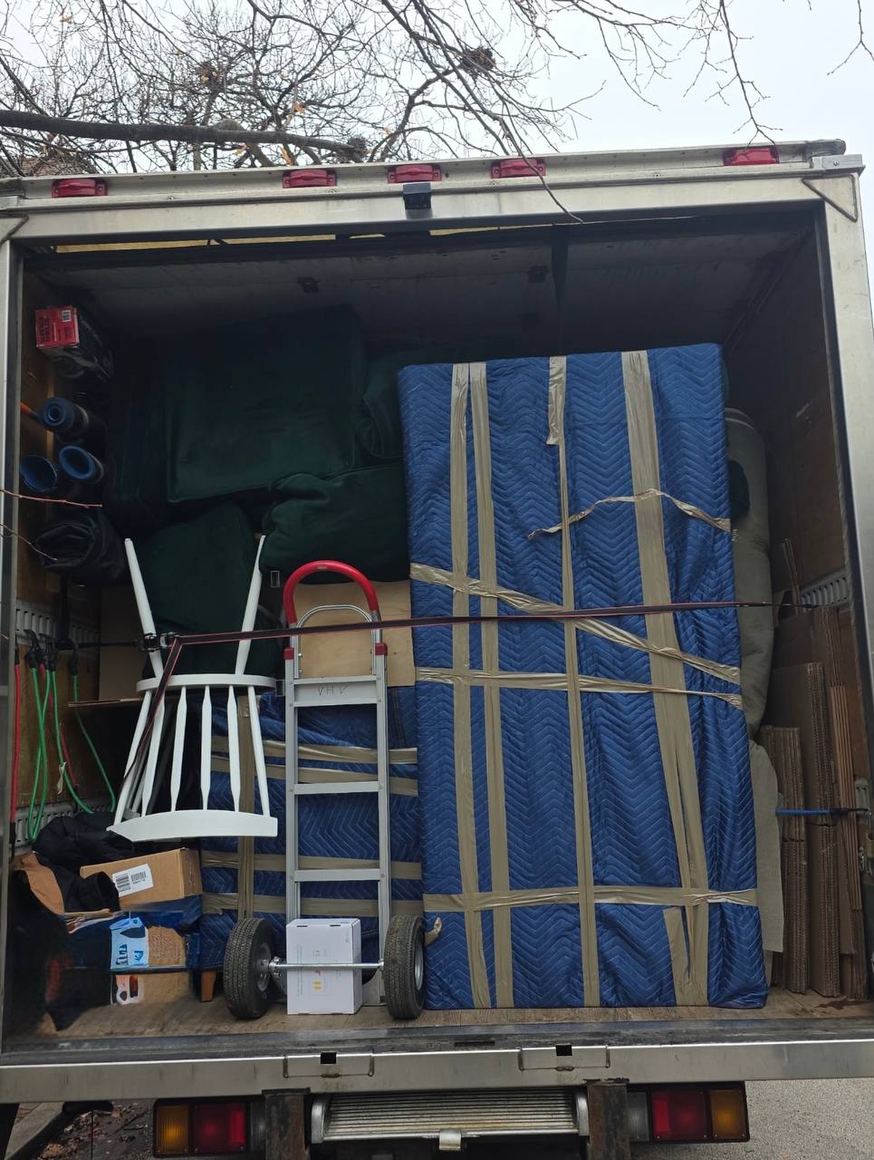 Organized moving truck with wrapped furniture
