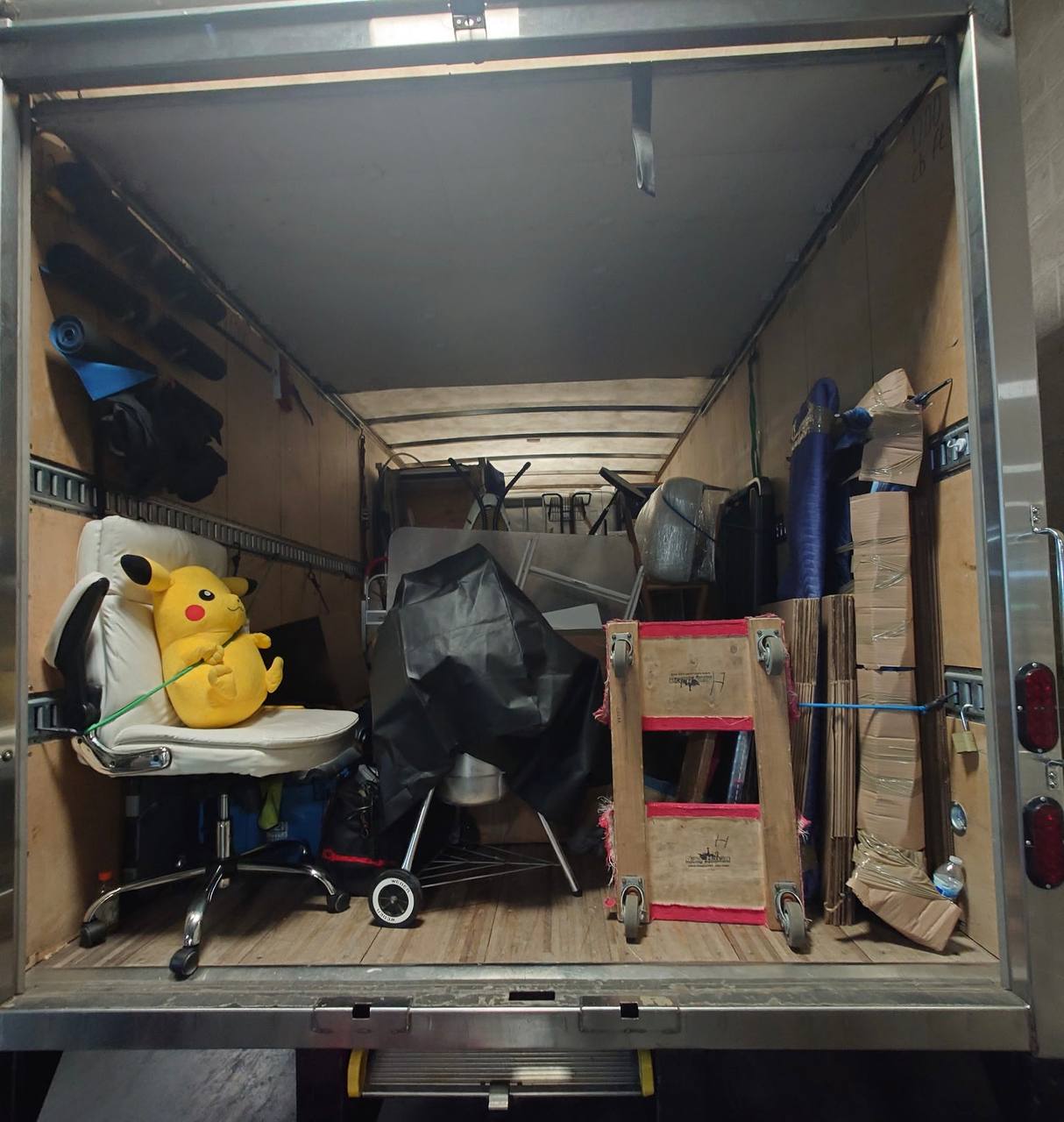 Moving truck with office chair and Pikachu