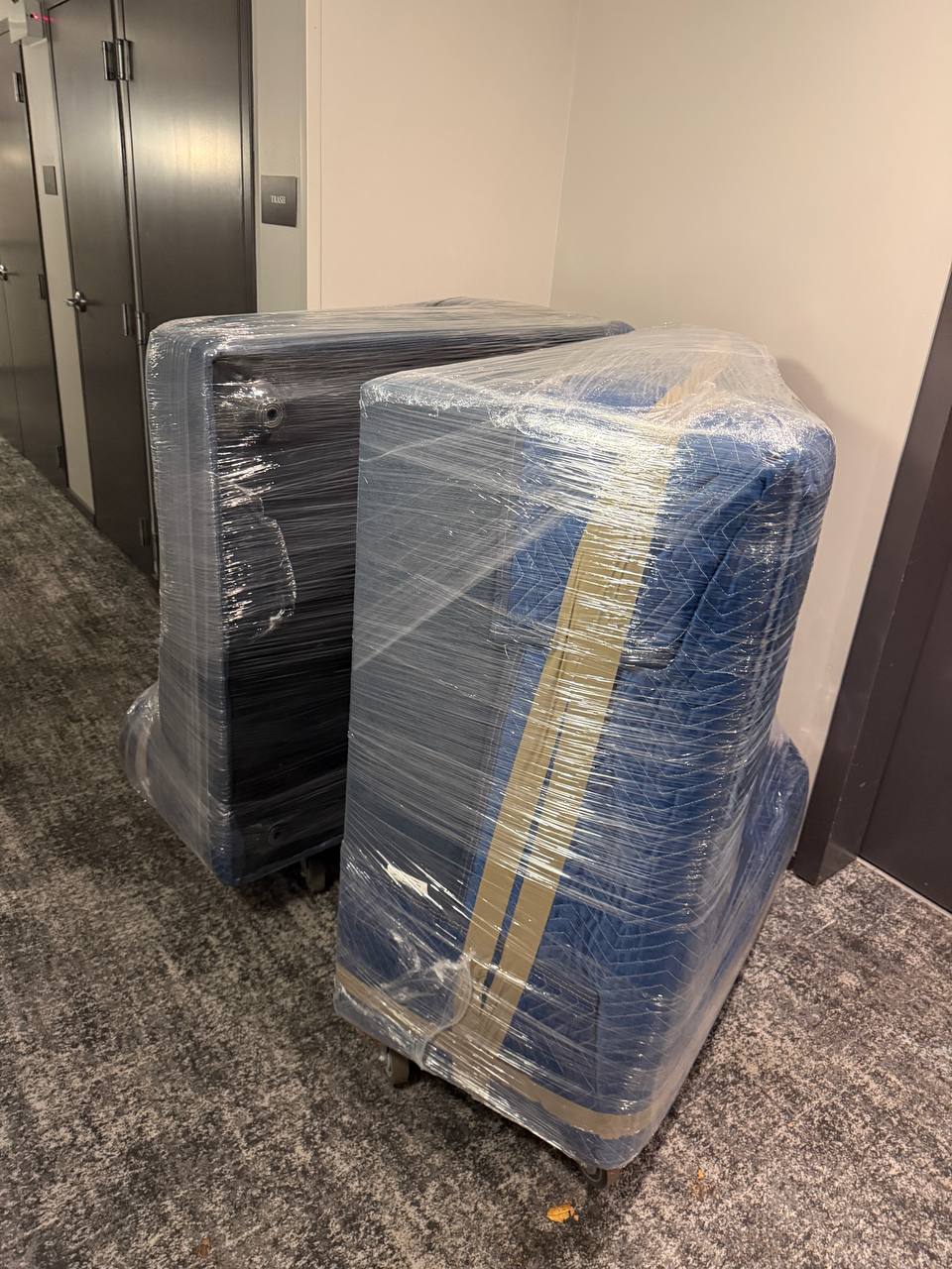 Wrapped office furniture in hallway
