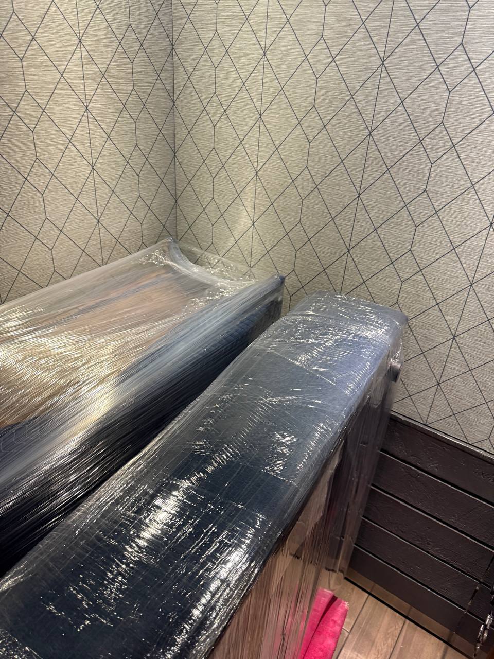 Wrapped furniture against geometric wall