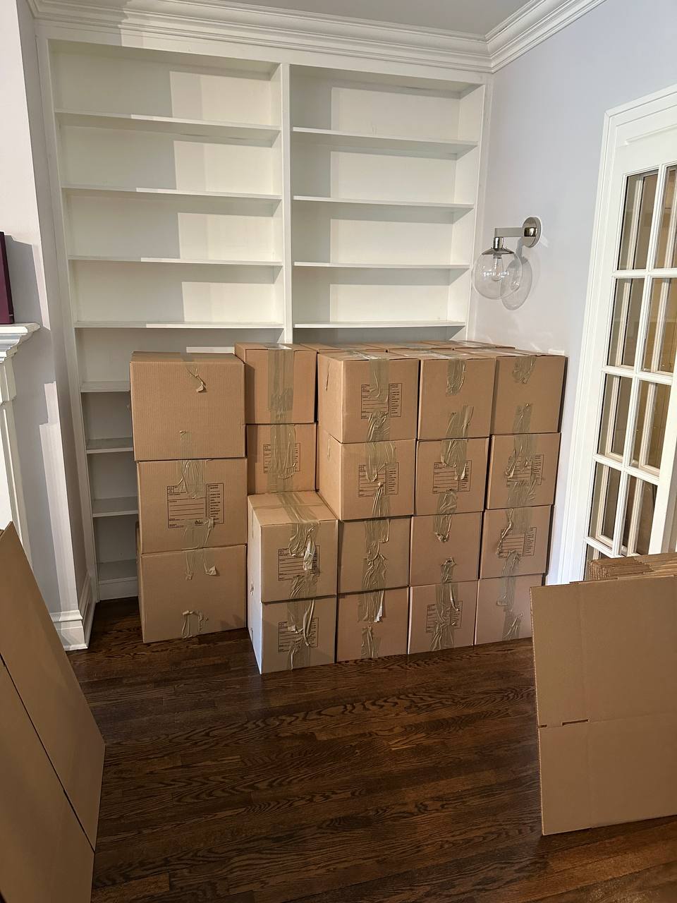 Packed boxes in front of bookshelves