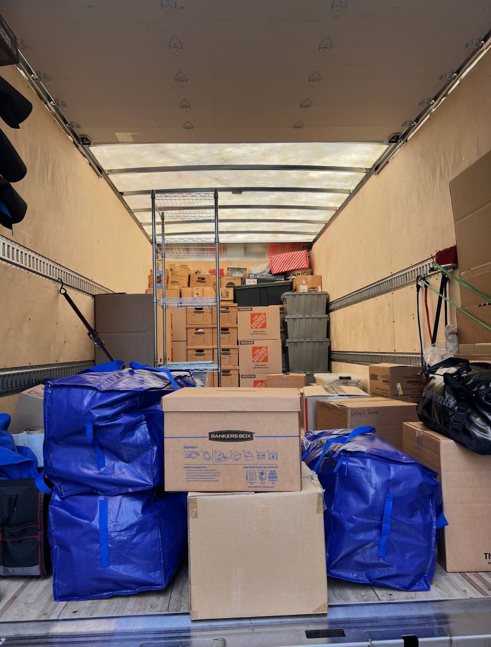 Office move with boxes and blue bags in truck